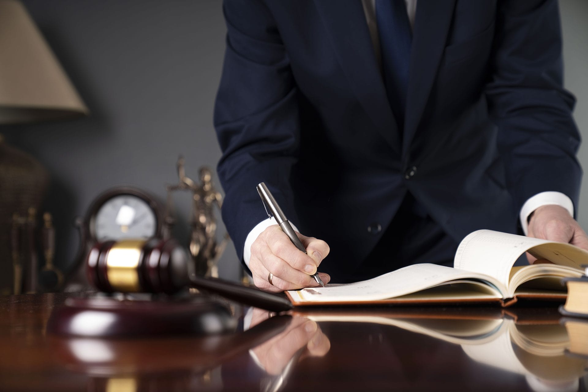 Estate planning with attorney; making notes at his desk.
