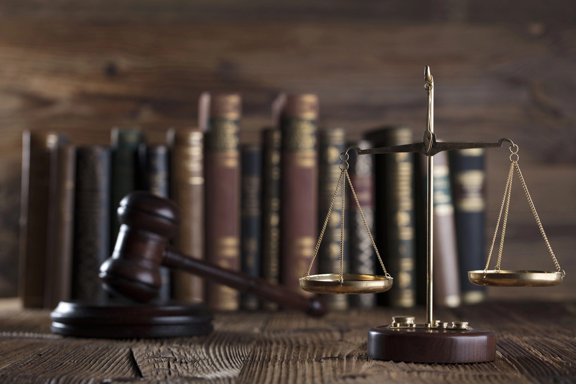Attorney legal books, scale of justice, and gavel in background